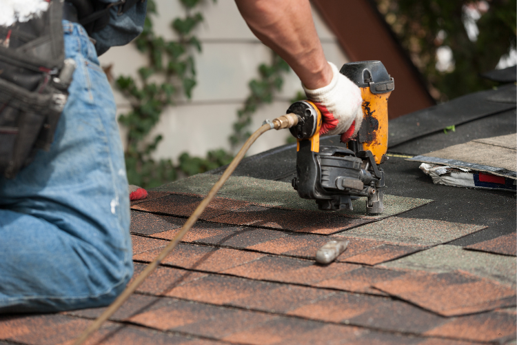 Roofing contractor working on a Kent home roof