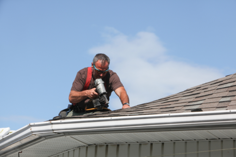 Roofing professional performing maintenance on a Puyallup home